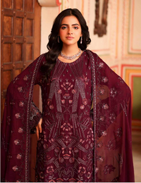 Woman wearing a maroon embroidered traditional outfit with a matching dupatta.